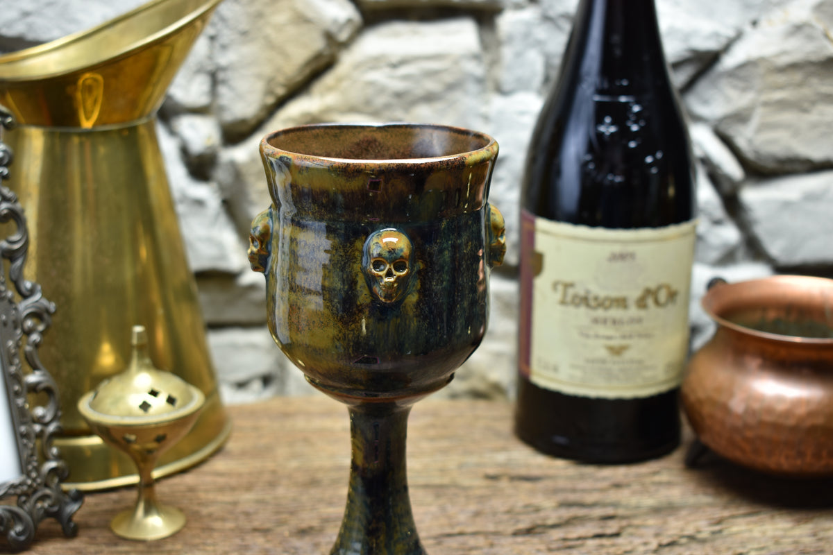 Handmade ceramic wine goblet with skulls - brown/blue/green effect glaze