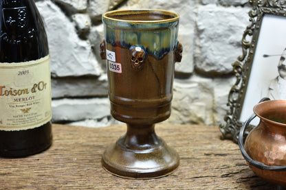 Handmade ceramic chalice with skulls - brown/green effect glaze