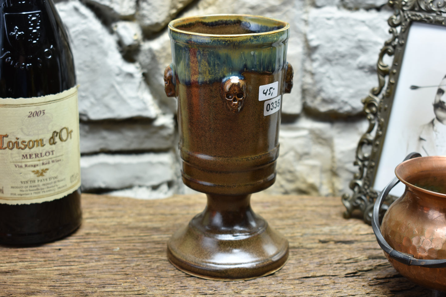 Handmade ceramic chalice with skulls - brown/green effect glaze