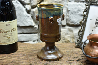 Handmade ceramic chalice with skulls - brown/green effect glaze