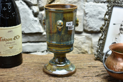 Handmade ceramic chalice with skulls - brown/green/blue effect glaze