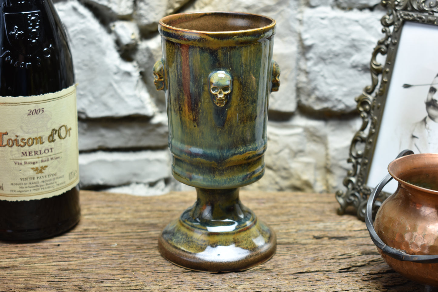 Handmade ceramic chalice with skulls - brown/green/blue effect glaze