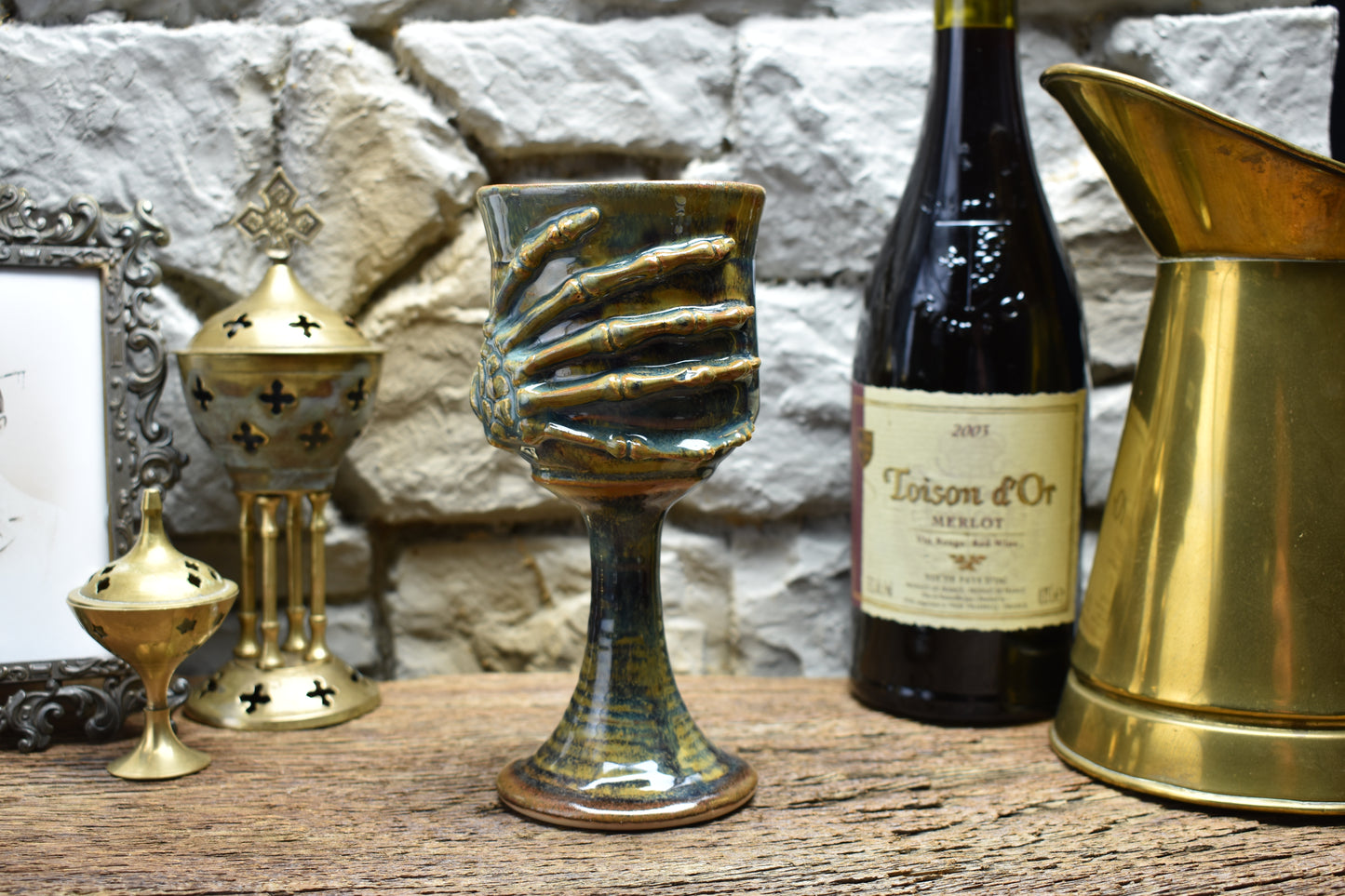 Handmade ceramic wine goblet with skeleton hand - brown/blue effect glaze