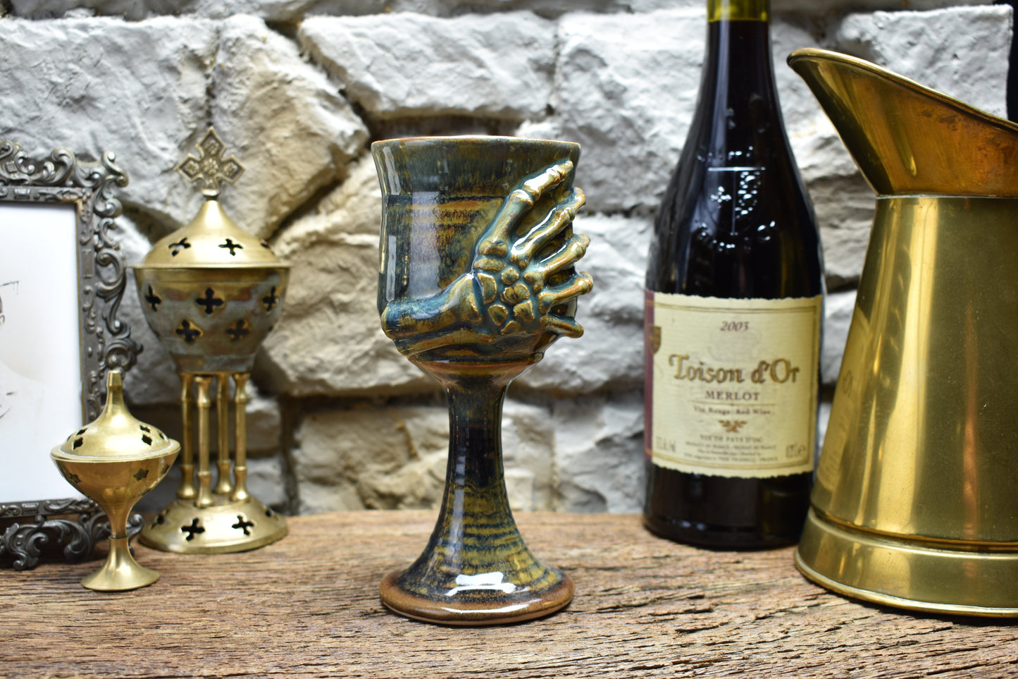 Handmade ceramic wine goblet with skeleton hand - brown/blue effect glaze