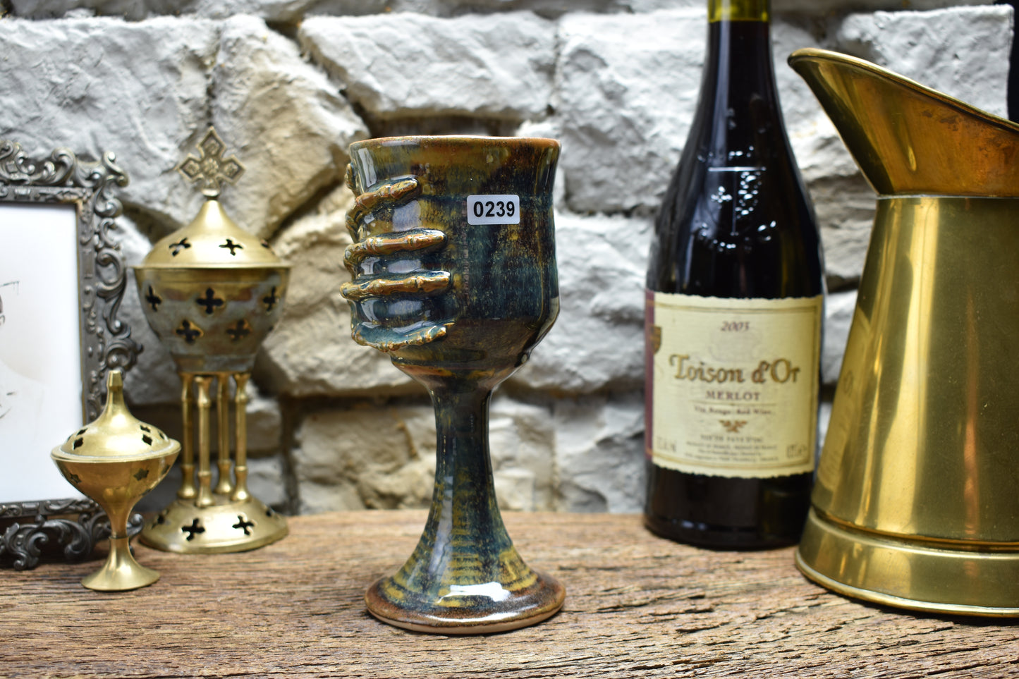 Handmade ceramic wine goblet with skeleton hand - brown/blue effect glaze