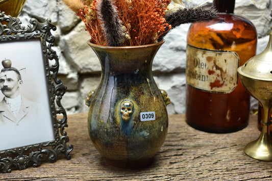 Handmade small vase with skulls brown/blue/green effect glaze