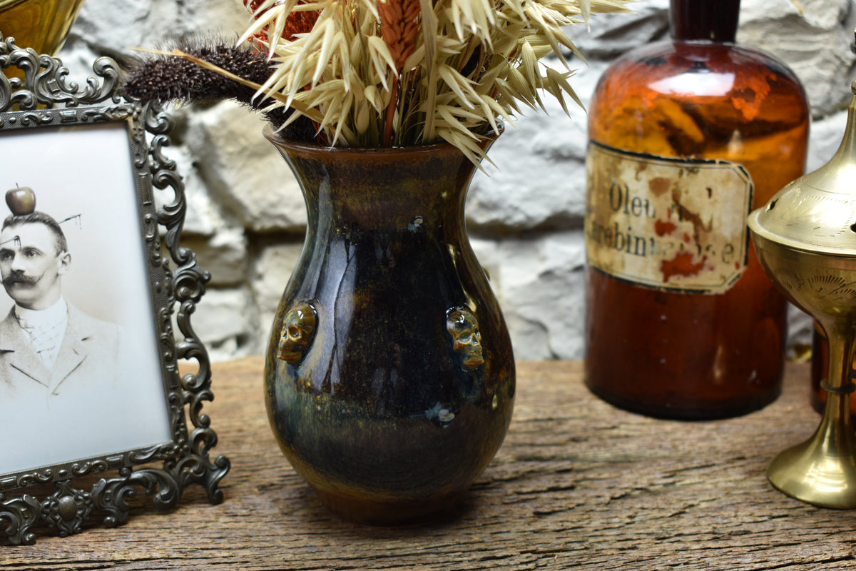 Handmade small vase with skulls brown/blue/green effect glaze