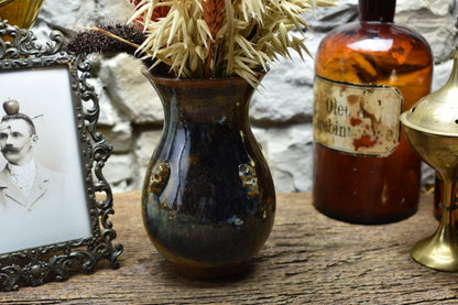Handmade small vase with skulls brown/blue/green effect glaze