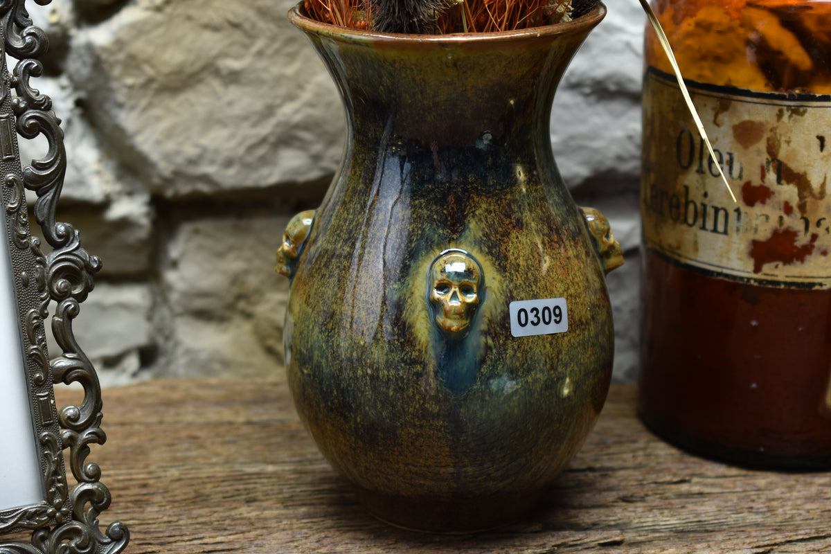 Handmade small vase with skulls brown/blue/green effect glaze