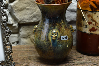 Handmade small vase with skulls brown/blue/green effect glaze