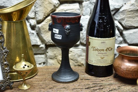 Handmade ceramic wine goblet with skulls - black/red glaze