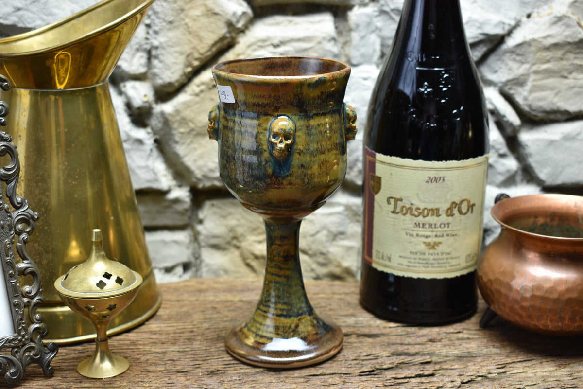 Handmade ceramic wine goblet with skulls - brown/blue/green effect glaze