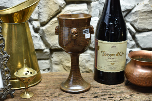 Handmade ceramic wine goblet with skulls - brown
