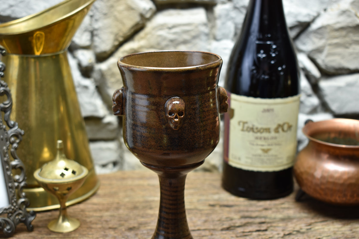 Handmade ceramic wine goblet with skulls - brown