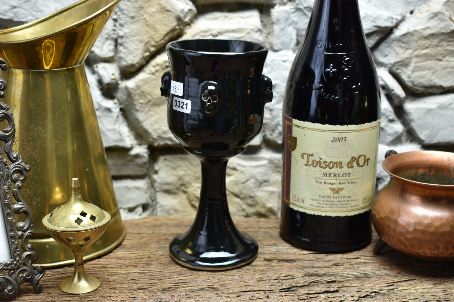 Handmade ceramic wine goblet with skulls - shiny black