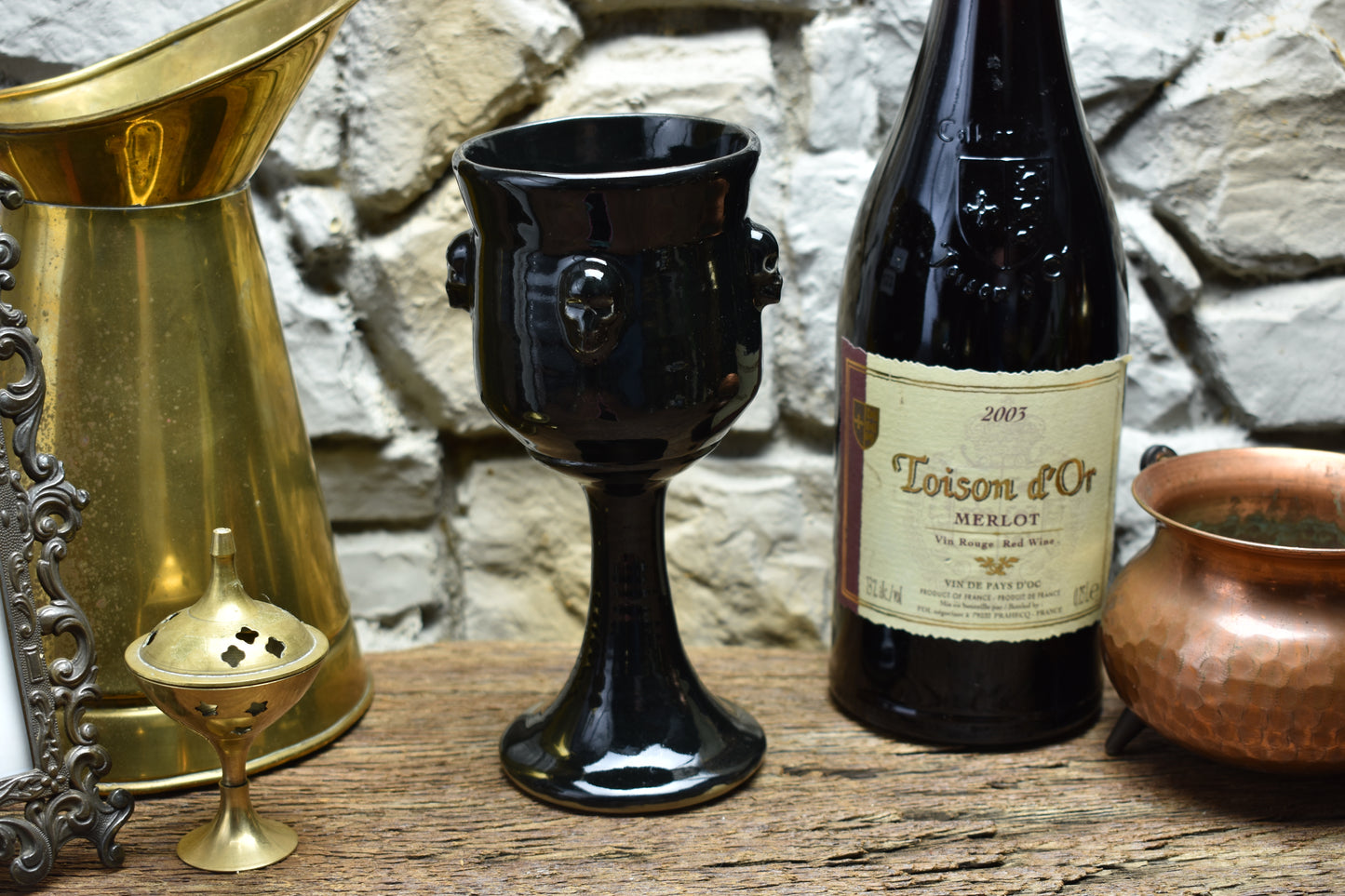Handmade ceramic wine goblet with skulls - shiny black