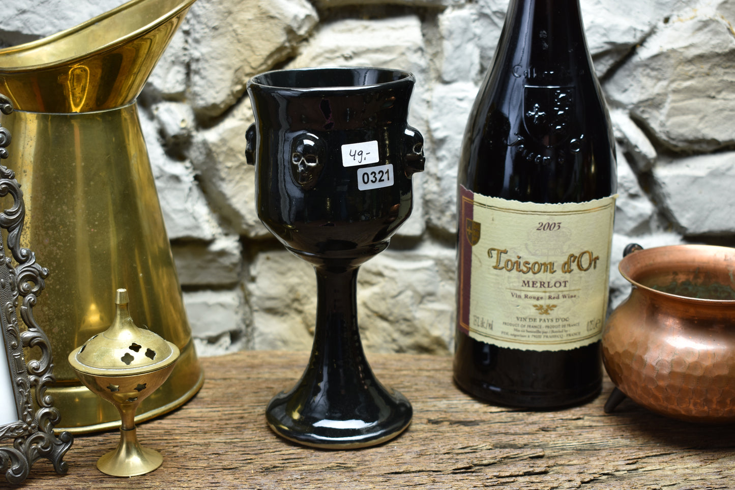 Handmade ceramic wine goblet with skulls - shiny black