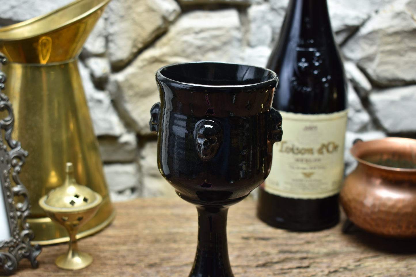Handmade ceramic wine goblet with skulls - shiny black