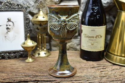 Handmade ceramic wine goblet with deathmoth - brown/green effect glaze