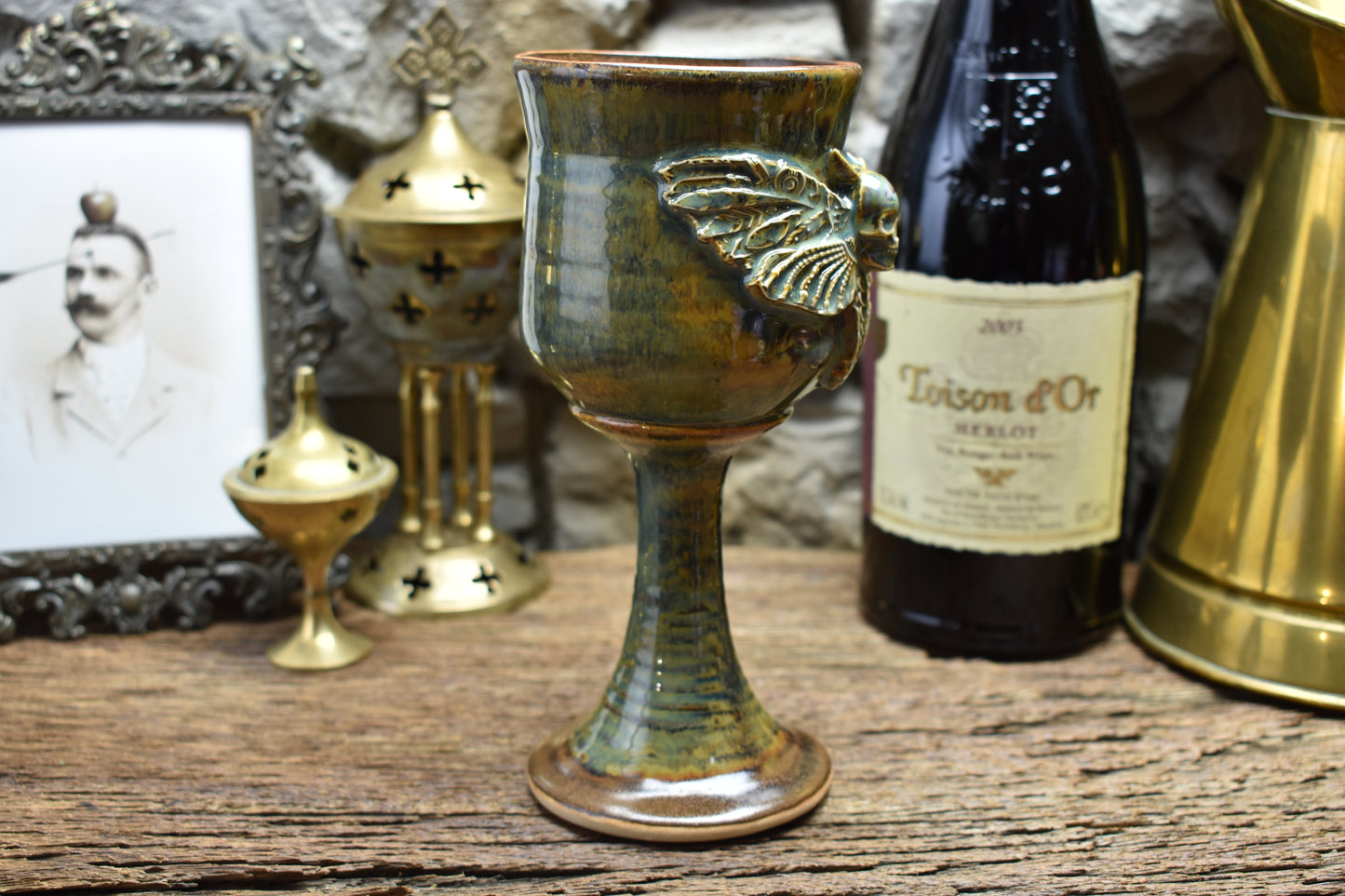 Handmade ceramic wine goblet with deathmoth - brown/green effect glaze