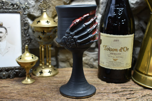 Handmade ceramic wine goblet with skeleton hand - black matt & red glaze