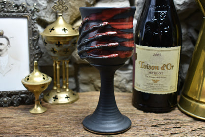 Handmade ceramic wine goblet with skeleton hand - black matt & red glaze