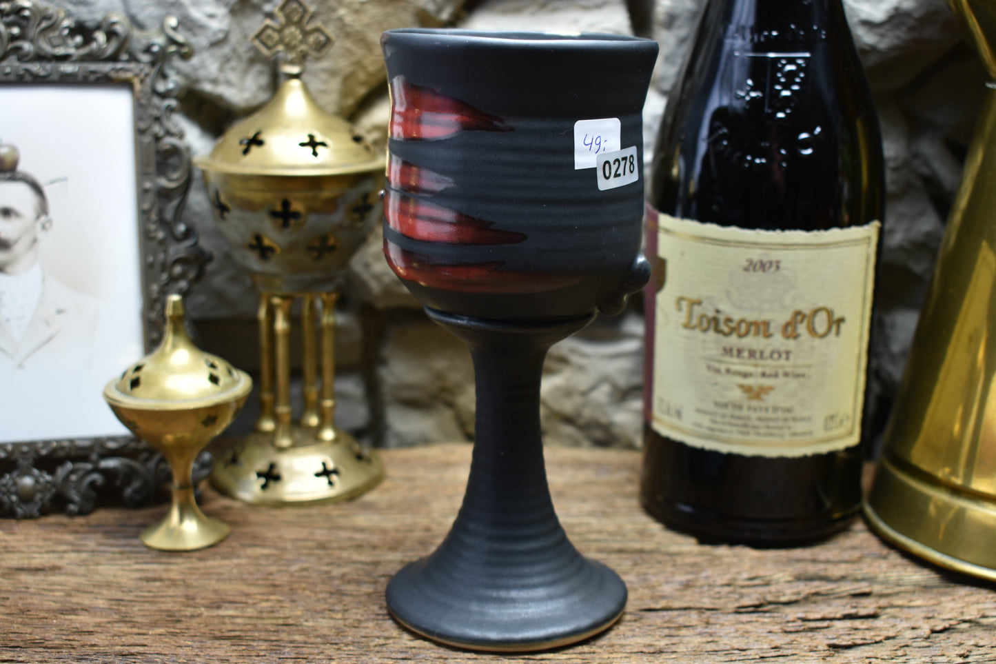 Handmade ceramic wine goblet with skeleton hand - black matt & red glaze