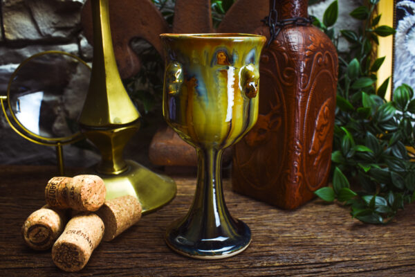 Handmade ceramic wine goblet with skulls and brown effect glaze