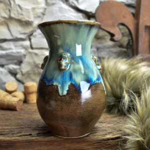 Handmade small vase with skulls brown/blue effect glaze