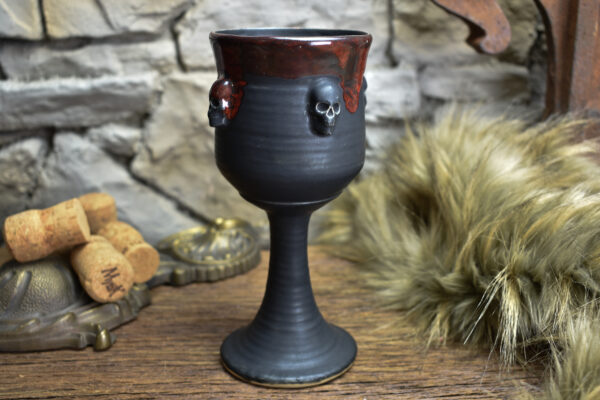 Handmade ceramic wine goblet with skulls black matt and red effect