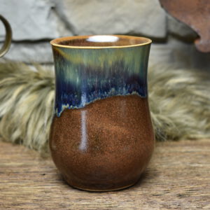 Handmade ceramic cup with matt brown and blue effect glaze